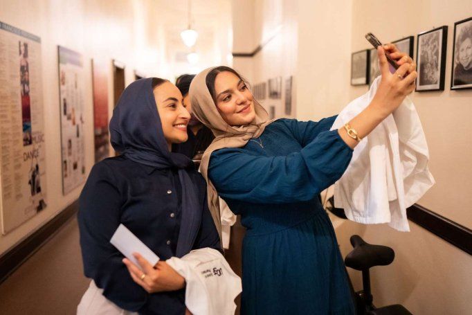 two students take selfie in hallway