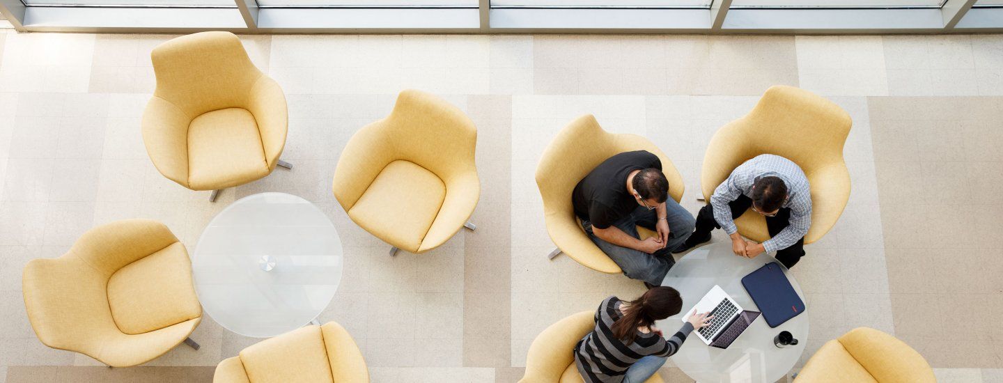 3 people working together in a lounge area