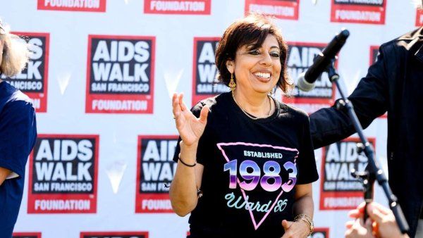 woman on step and repeat wave at crowd