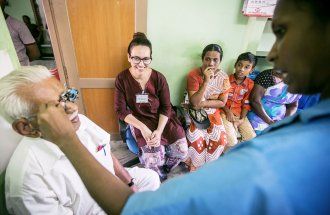 UCSF student watching an eye exam in Indian clinic