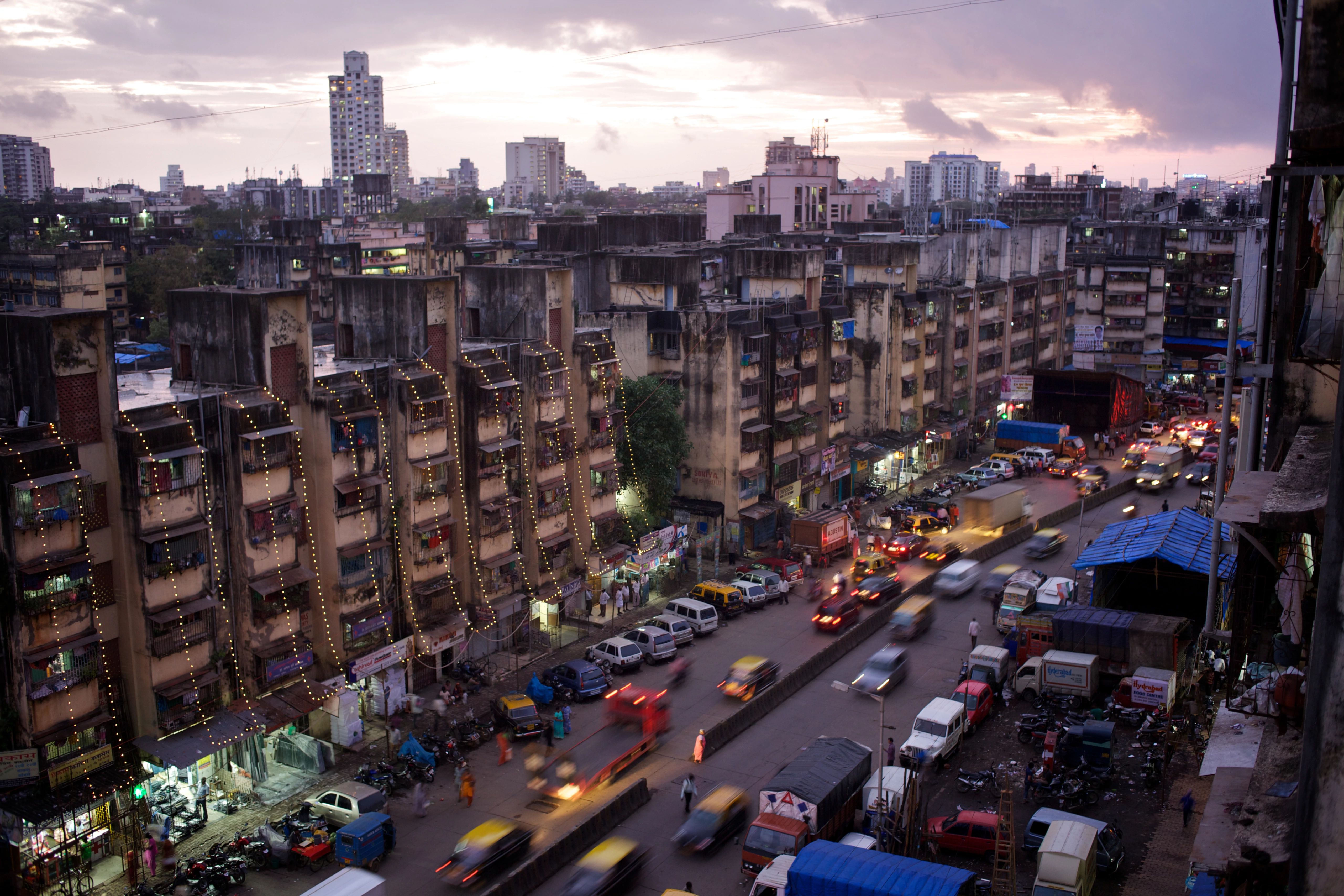 a view of a city street filled with traffic surrounded by tall buildings