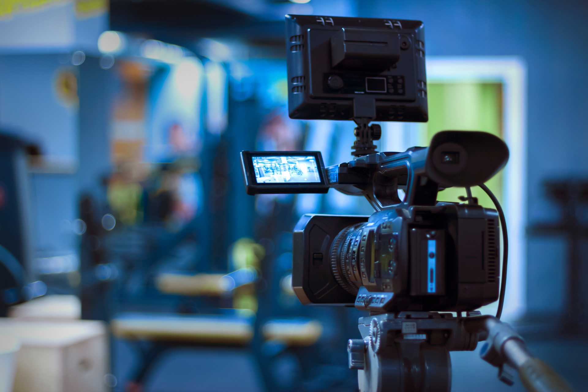 A video camera standing inside a dark room. 