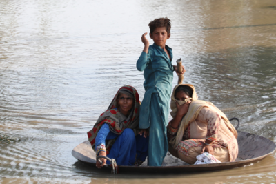 A young boy and his family flee flooding in Pakistan