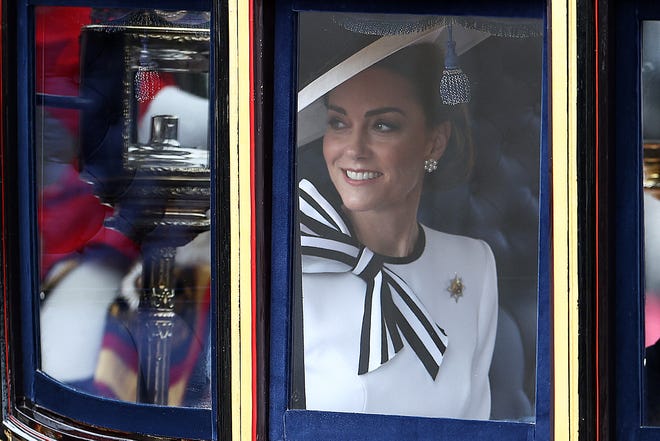 Princess Kate smiles inside the Glass State Coach on her way to Horse Guards Parade for Trooping the Colour, an event celebrating King Charles' birthday, in London on June 15, 2024. It was her first public appearance since she revealed her cancer diagnosis.