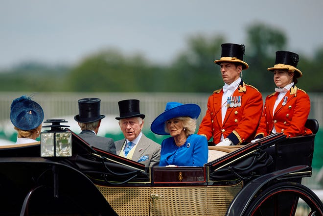 Britain's King Charles III and Britain's Queen Camilla arrive on a carriage, during the Royal Procession, on the first day of the Royal Ascot horseracing meeting in Ascot, west of London, on June 18, 2024.