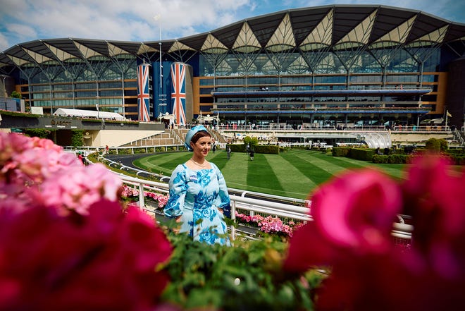 A race goer arrives to attend the second day of the Royal Ascot horse racing meeting, in Ascot, west of London, on June 19, 2024.