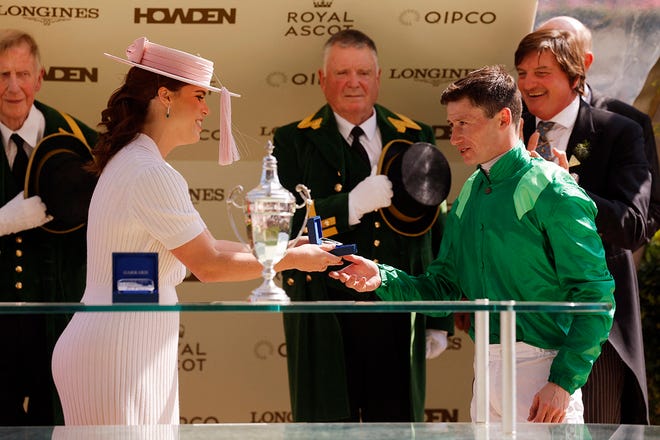 Princess Eugenie of York awards a trophy to Oisin Murphy after winning the 15:45 Duke Of Cambridge Stakes riding Running Lion on June 19, 2024.