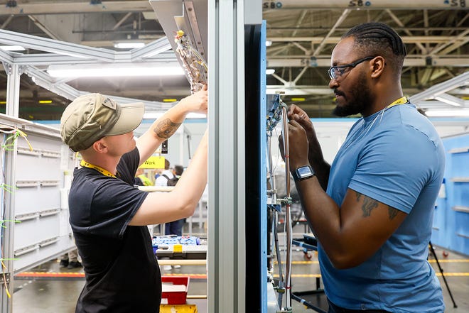 Timothy Well, left, and Derrick Farmer work on projects as they train on the electrical systems at the Foundational Training Center Tuesday, June 25, 2024 in Renton, WA.