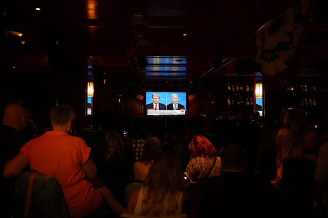 People watch the CNN presidential debate between U.S. President Joe Biden and Republican presidential candidate former President Donald Trump at a debate watch party at The Continental Club on June 27, 2024 in Los Angeles, California. Biden and Trump are facing off in the first presidential debate of the 2024 presidential cycle.