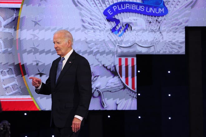 Democrat candidate, U.S. President Joe Biden takes the stage to attend a presidential debate with Republican candidate, former U.S. President Donald Trump, in Atlanta, Georgia.