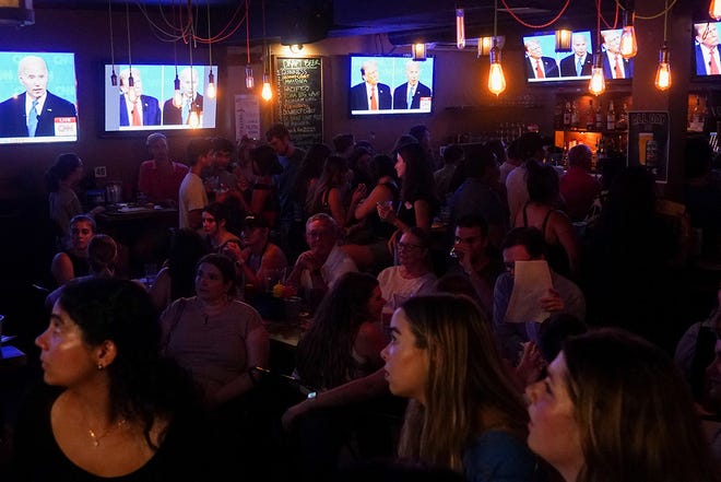 People attend a watch party for the first U.S. presidential debate hosted by CNN in Atlanta, at Union Pub on Capitol Hill in Washington.