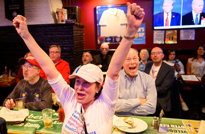 Patrons react during a watch party for the first presidential debate of the 2024 presidential elections between President Joe Biden and former President and Republican presidential candidate Donald Trump at a pub in San Francisco, California, on June 27, 2024. The presidential debate is taking place in Atlanta, Georgia.