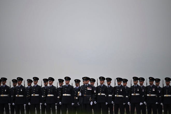 The Queen's Colour Squadron prepare for the arrival of the coffin of Queen Elizabeth II at RAF Northolt, London, Tuesday Sept. 13, 2022, from where it will be taken to Buckingham Palace.