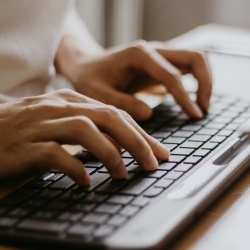 Hands typing on a keyboard