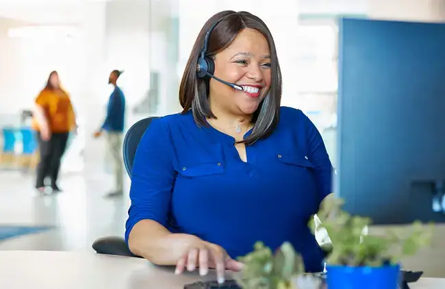 a Virginia Credit Union employee taking a call at their desk