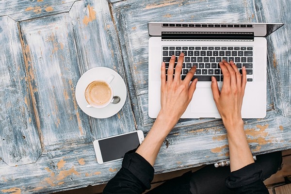 Image of a person typing on a laptop