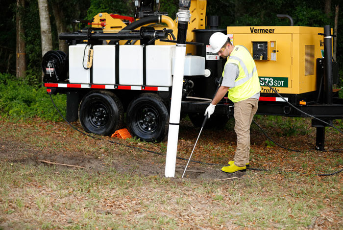 A man vacuum excavating