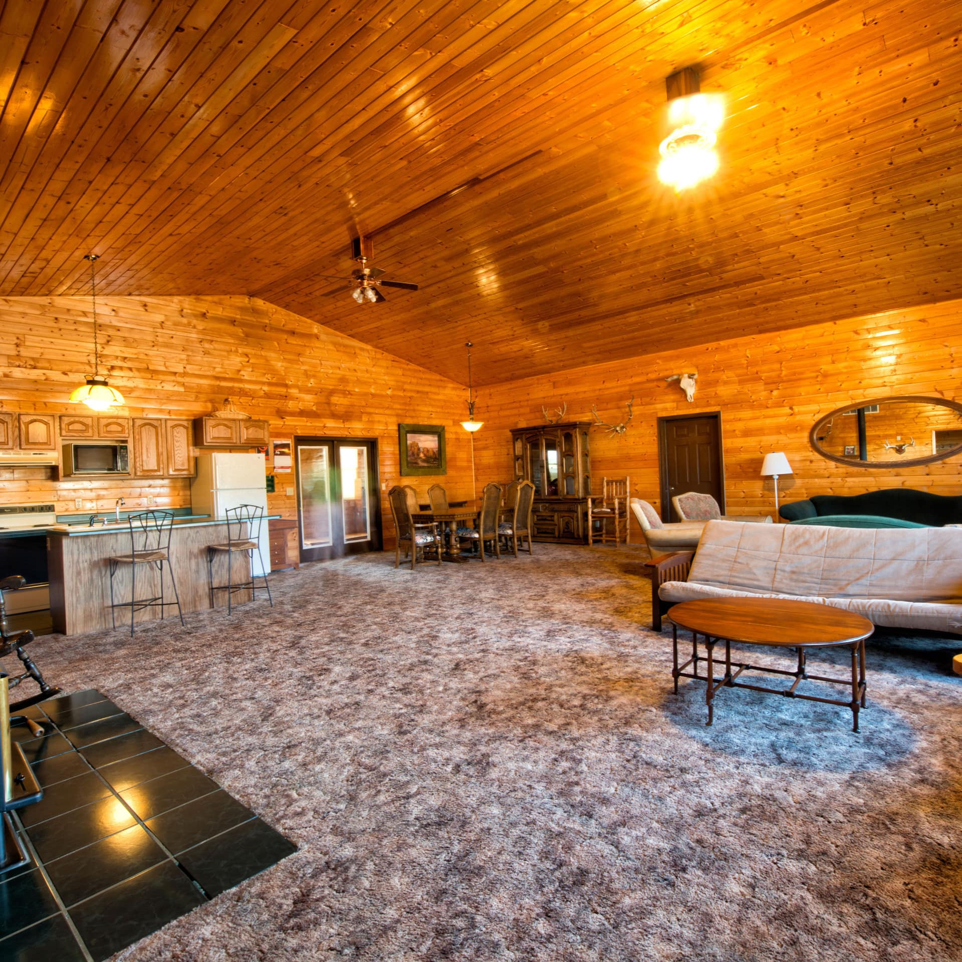 A bright living area with wood paneling on the walls and ceiling