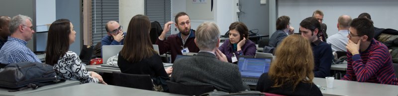 11 people round a table having a discussion