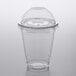 A Choice clear plastic cup with a PET dome lid on a table.