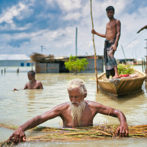 a man is trying to walk in a flooded area