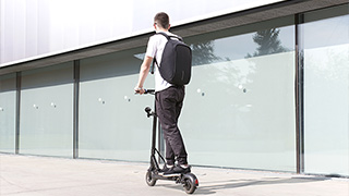 man riding an e-scooter