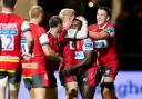 Gloucester's Christian Wade congratulated by  teammates after scoring try