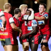 Gloucester's Christian Wade congratulated by  teammates after scoring try