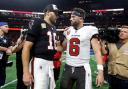 Atlanta Falcons quarterback Kirk Cousins (18) talks to Tampa Bay Buccaneers quarterback Baker Mayfield (6) after the Falcons defeated the Buccaneers during overtime in an NFL football game Thursday, Oct. 3, 2024, in Atlanta. (AP Photo/Butch Dill)