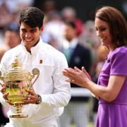 Carlos Alcaraz (left) is presented with the trophy by the Princess of Wales after victory in the Gentlemen's Singles Final against against Novak Djokovic