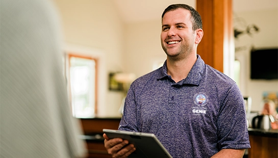 Window Genie team member smiling and holding clipboard.