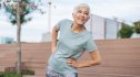 A mature woman practicing hip bursitis exercises to ease pain