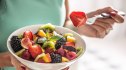 Woman eating a bowl of fruit