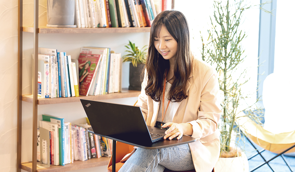 woman smiling while using laptop