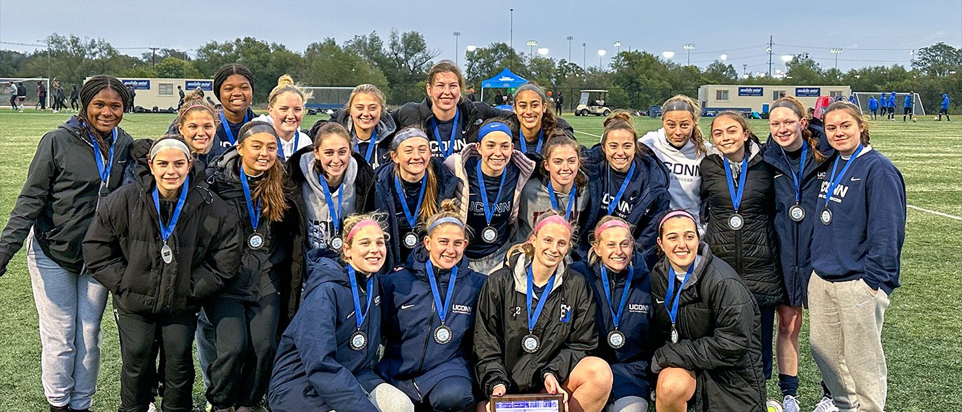 team view of soccer team with champion medals and plaque