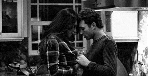 a man and woman standing in a kitchen next to each other