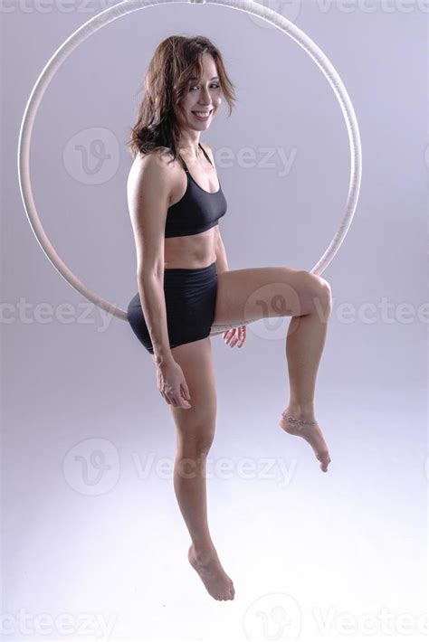 A female Aerial hoop gymnast performing exercises on an Aerial hoop 15985971 Stock Photo at Vecteezy