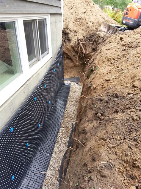 a bench sitting on top of a pile of dirt next to a house under construction