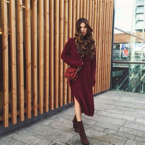 Picture Of burgundy sweater dress, brown suede boots and a red bag