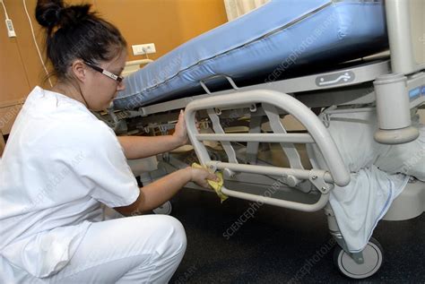 Nurse cleaning hospital bed - Stock Image - C001/3108 - Science Photo Library