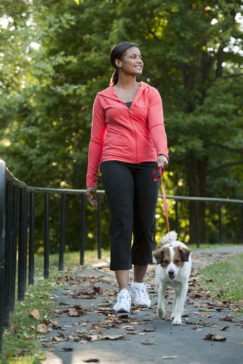 A woman walking her dog | SNAP-Ed