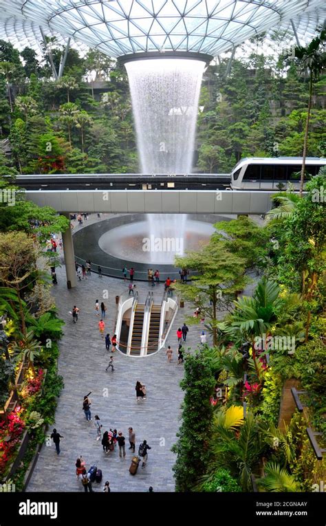 The Jewel waterfall monorail gardens and visitors Changi Airport Singapore Stock Photo - Alamy