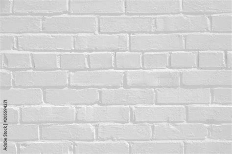 Faded white painted brick wall surface with highlights and shadows. Neutral light gray flat ...