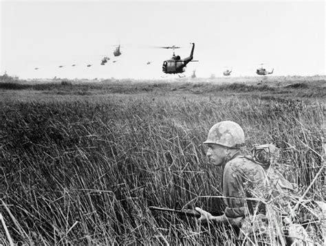 Soldier Crouching In Mekong Delta by Bettmann