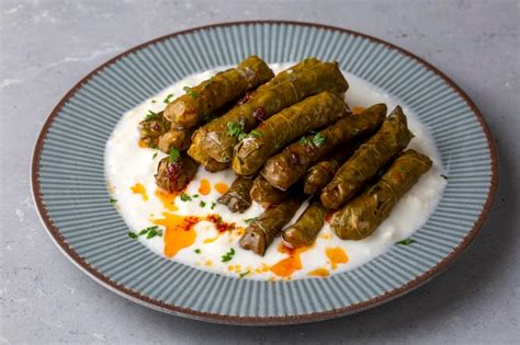 Premium Photo | Delicious dolma (sarma) stuffed grape leaves rice, white yogurt sauce. lebanese ...