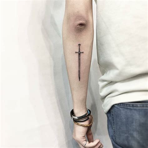 Little sword tattoo on the forearm - Tattoogrid.net