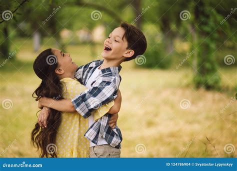 Little kids hugging. stock photo. Image of love, flower - 124786904