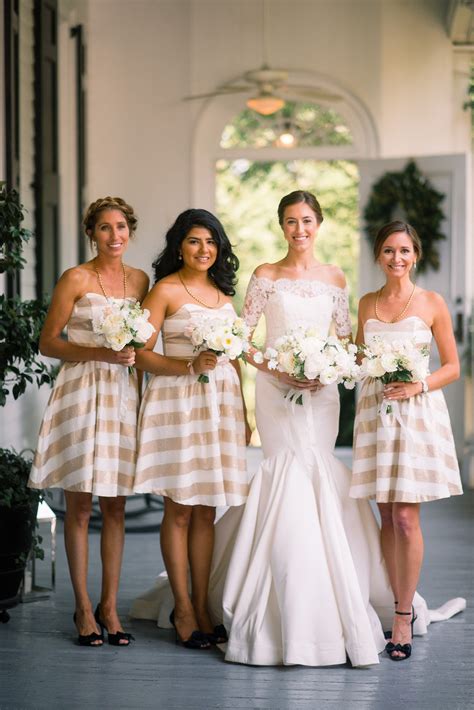 four bridesmaids pose for a photo in their dresses