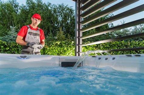 Premium Photo | Hot tub jacuzzi installer testing newly installed spa inside garden gazebos ...