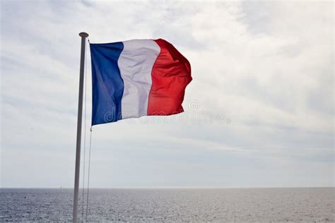 Flag Of France Waving In The Wind Against White Cloudy Blue Sky. French Flag Stock Image - Image ...